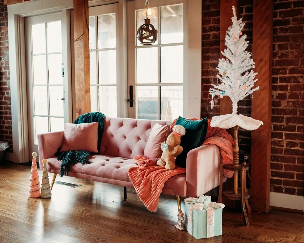 Candyland-inspired Christmas photo set with pink couch and gingerbread decor at Studio 270 Powder Springs.