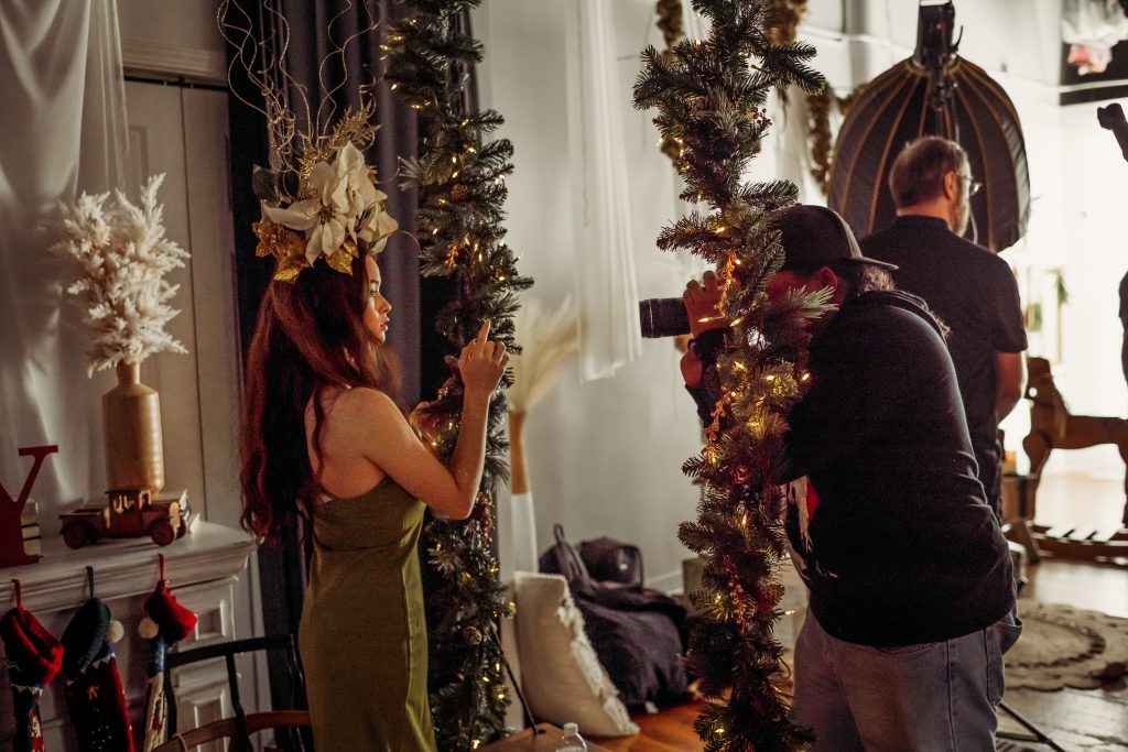 Photographer capturing a Christmas-themed portrait inside Studio 270 during a holiday event.
